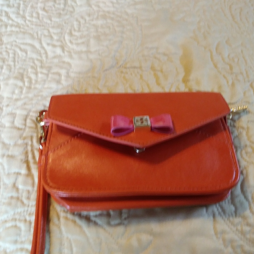Tory Burch orange leather wristlet with 3 card slo